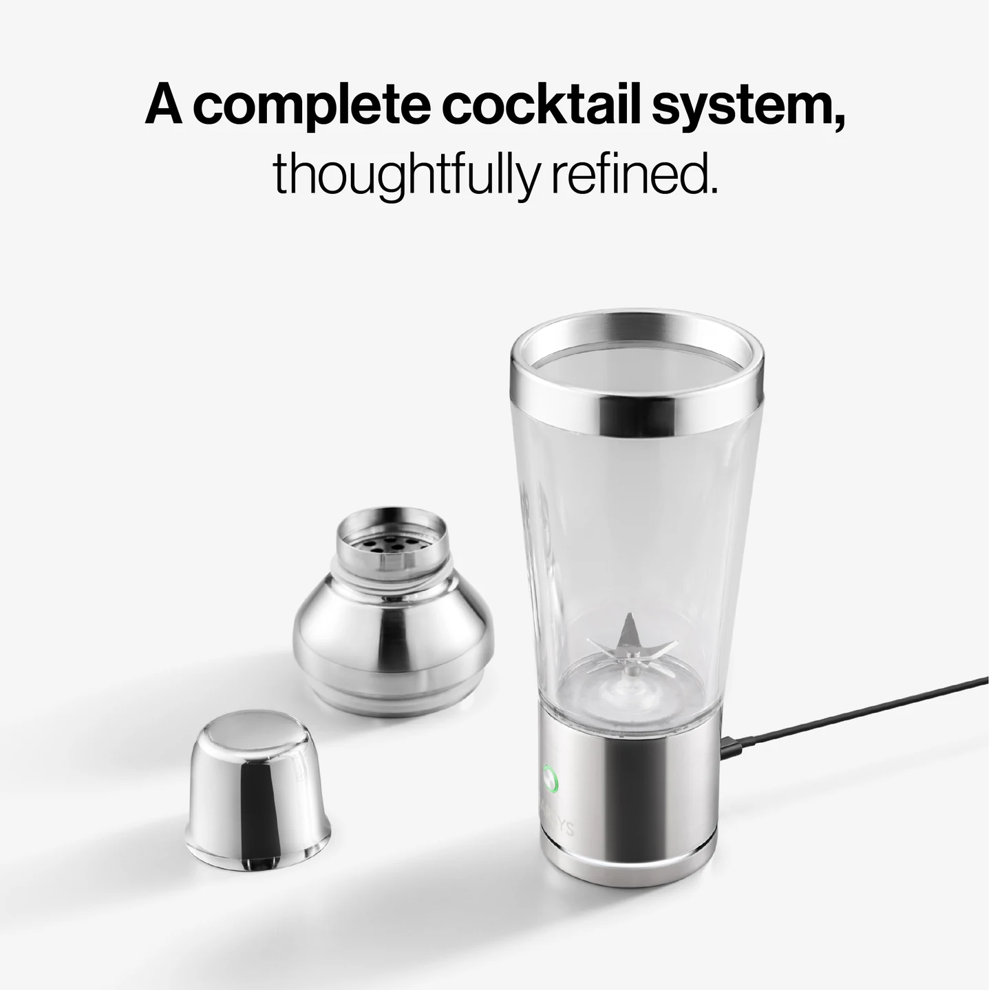 Panel text: “A complete cocktail system, thoughtfully refined.” Shaker Pro with its cap and strainer removed, and a cable connected to the base.
